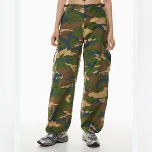 TNA of Aritzia denim Camouflage Cargo Pants with drawstring hem.